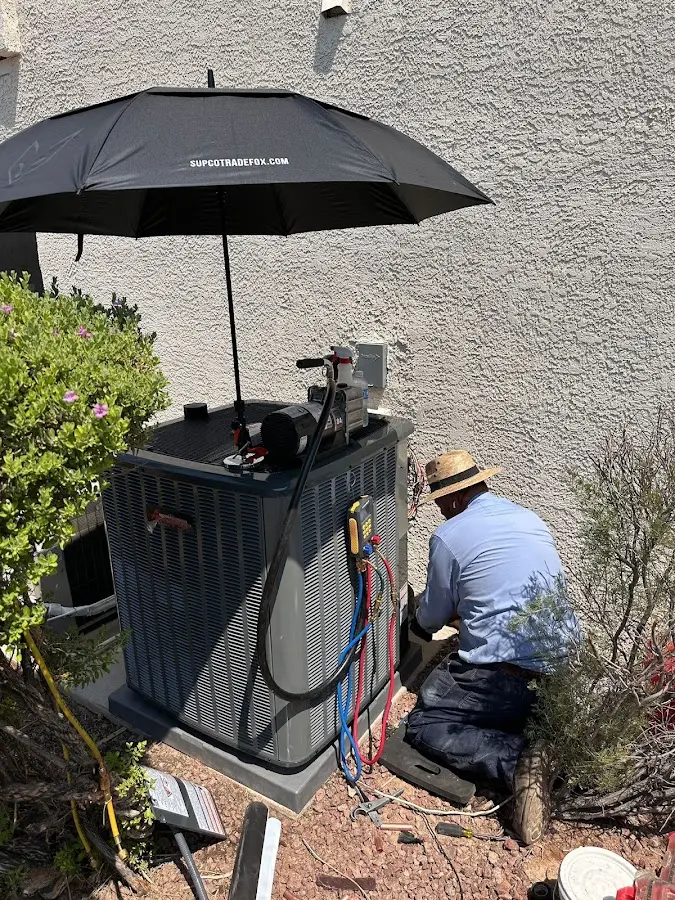 HVAC technician performing outdoor AC maintenance in New Philadelphia